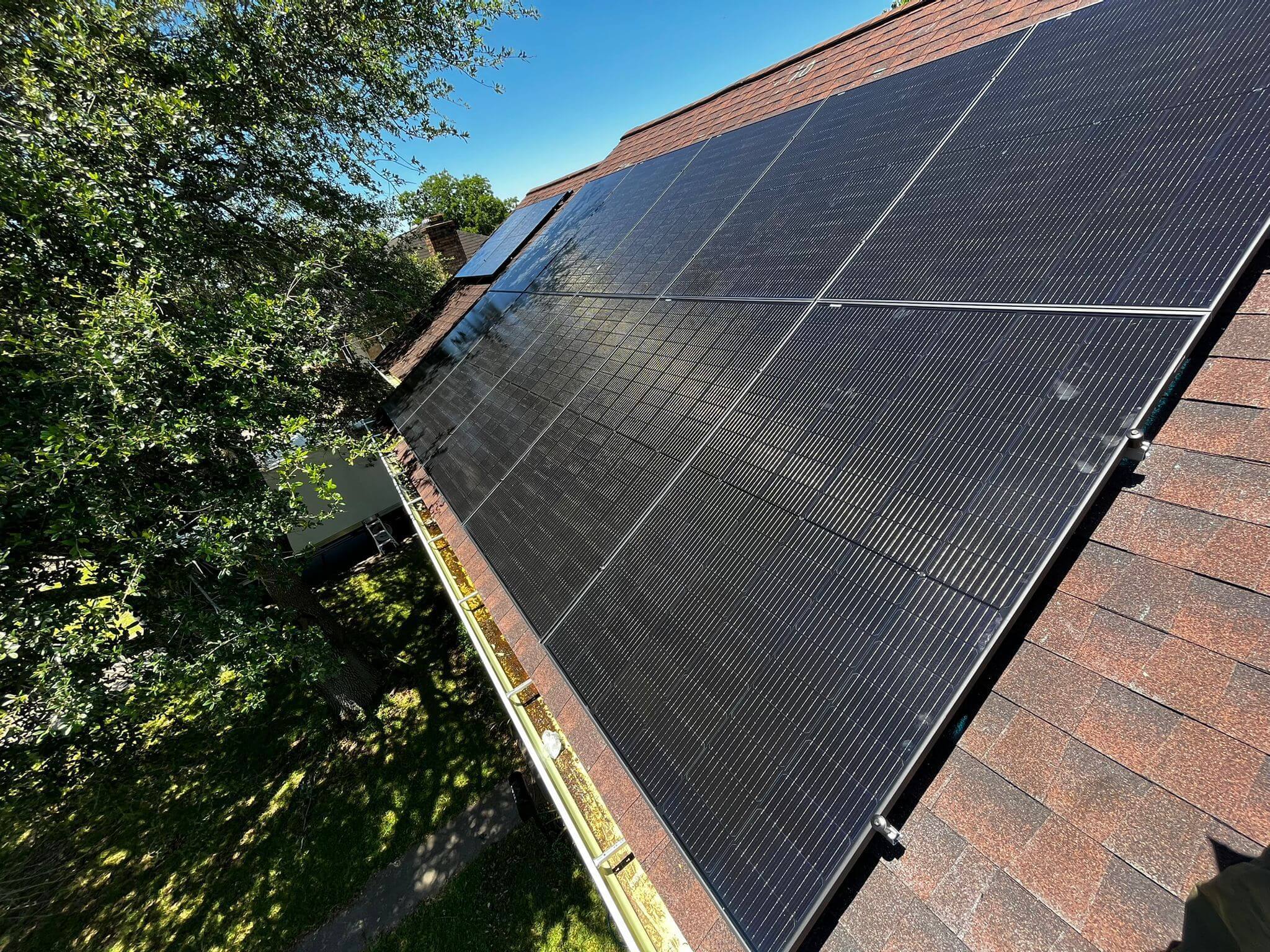 Black solar PV panels installed on a rooftop in Texas