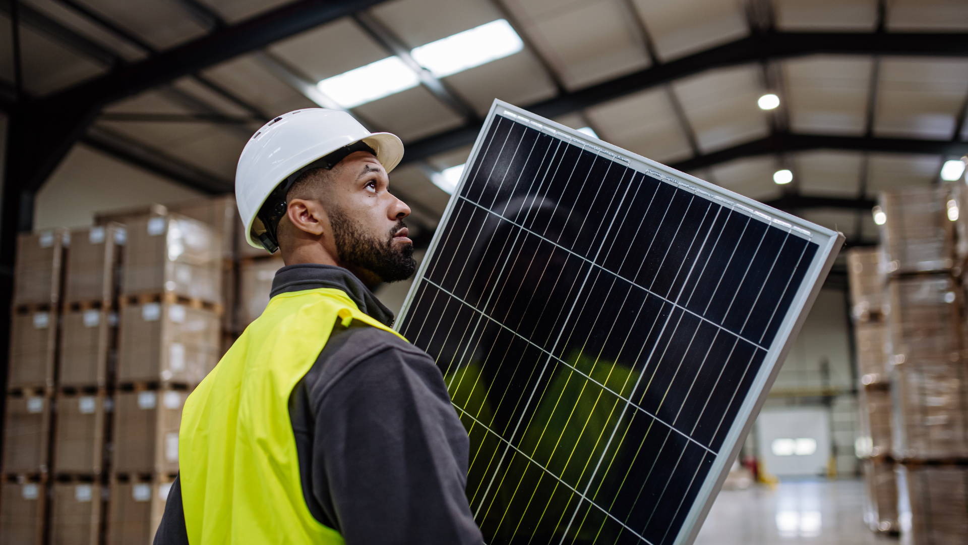 Solar installer holding a solar panel