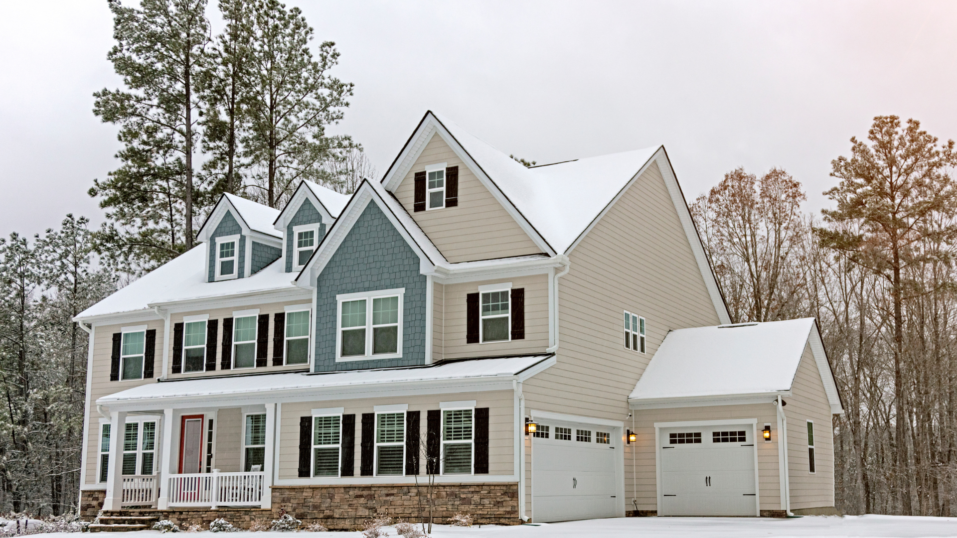 House during winter covered in snow with a snowy roof and yard